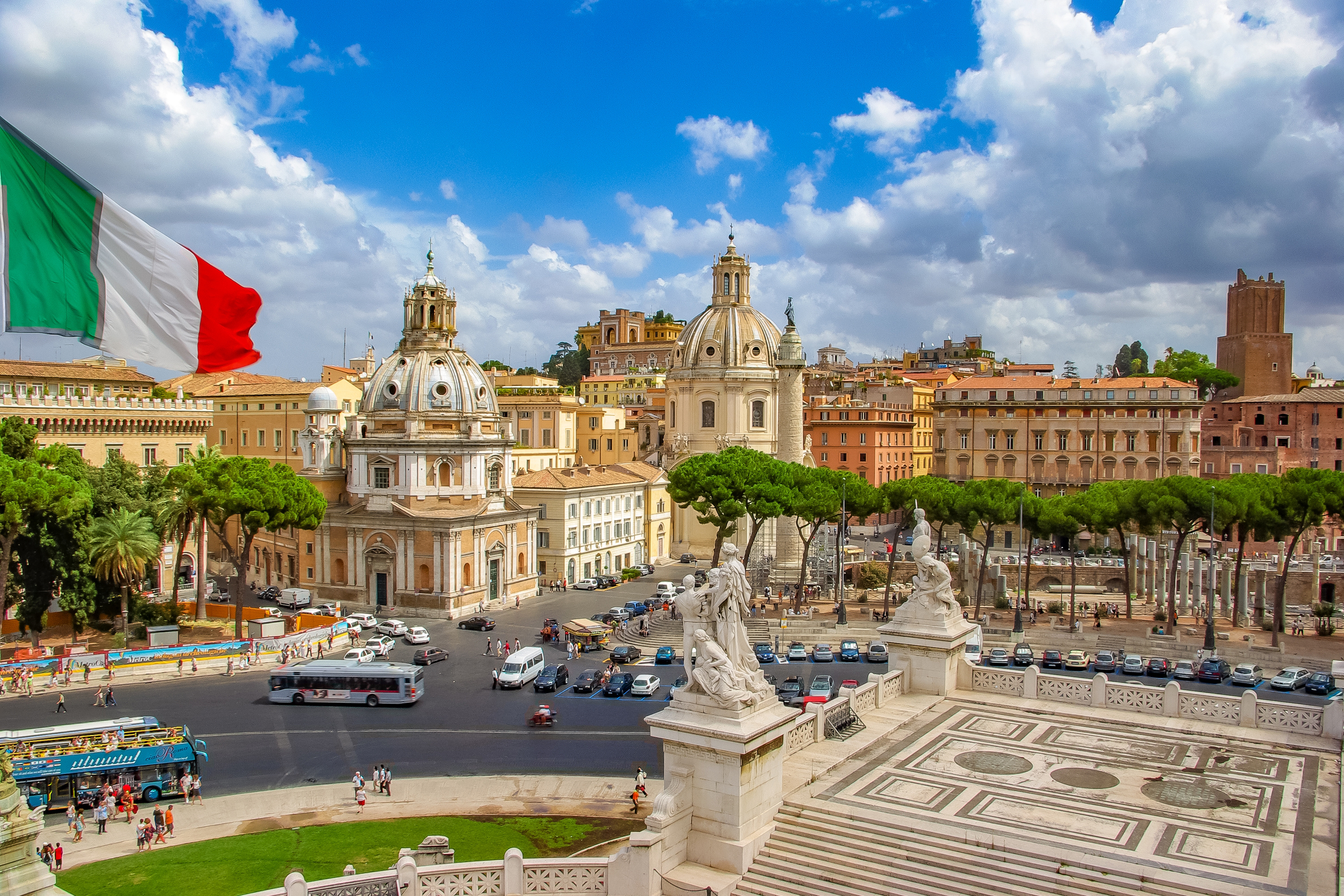 Italian flag against the backdrop of the city where you can get a residence permit in Italy when buying real estate