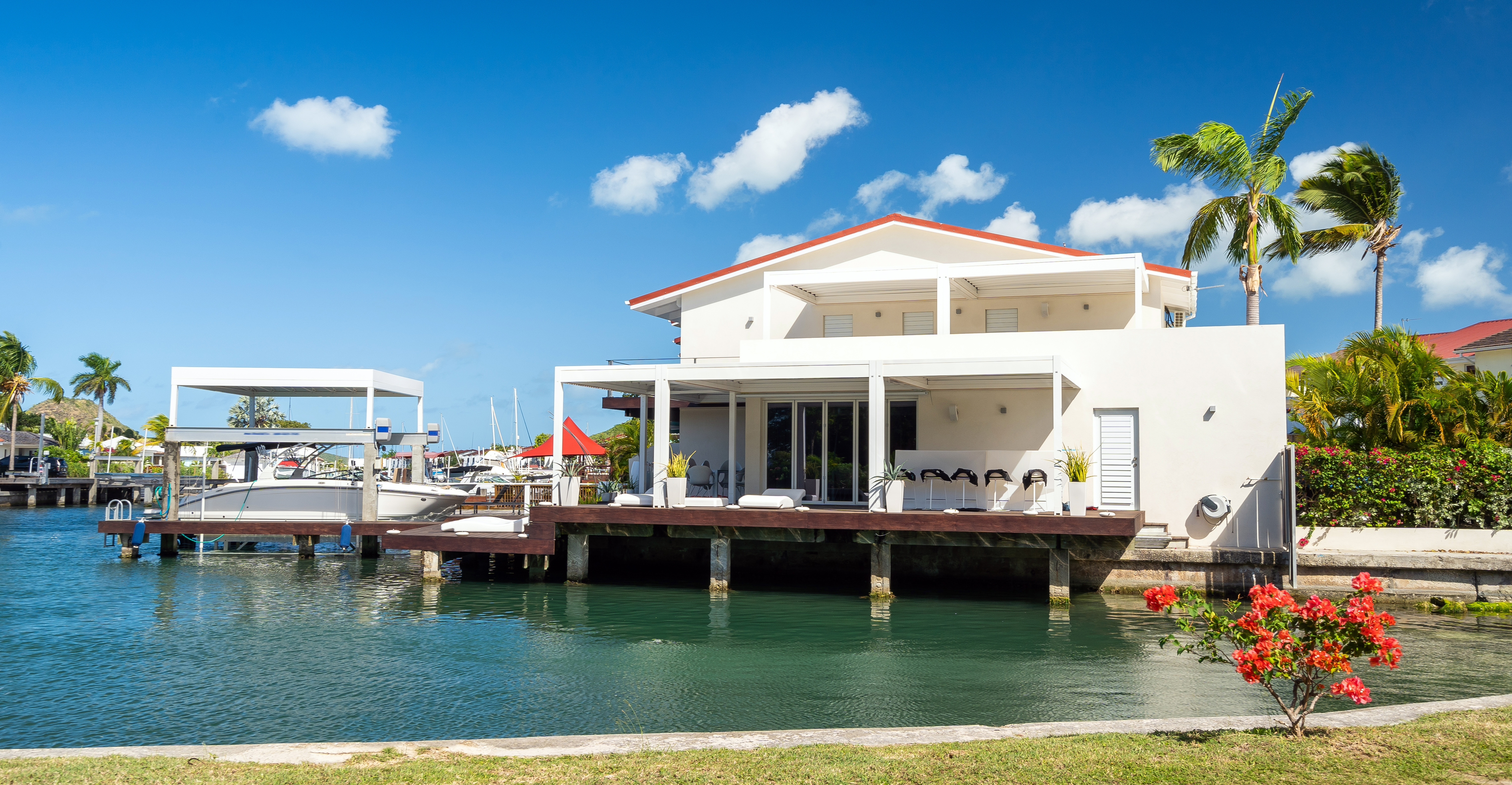 Modern waterfront villa in Antigua and Barbuda — luxury Caribbean real estate with terrace, dock, and lagoon views